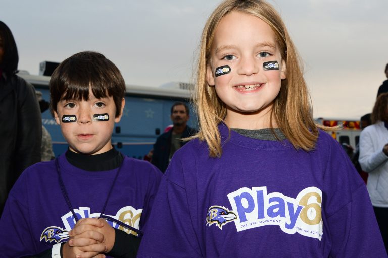 Two kids smiling in a NFL Play 60 event.