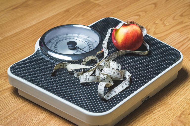 fitness challenge ideas: scale with apple and a measuring tape