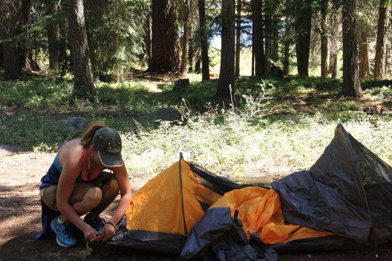 primitive camping. Women setting camp