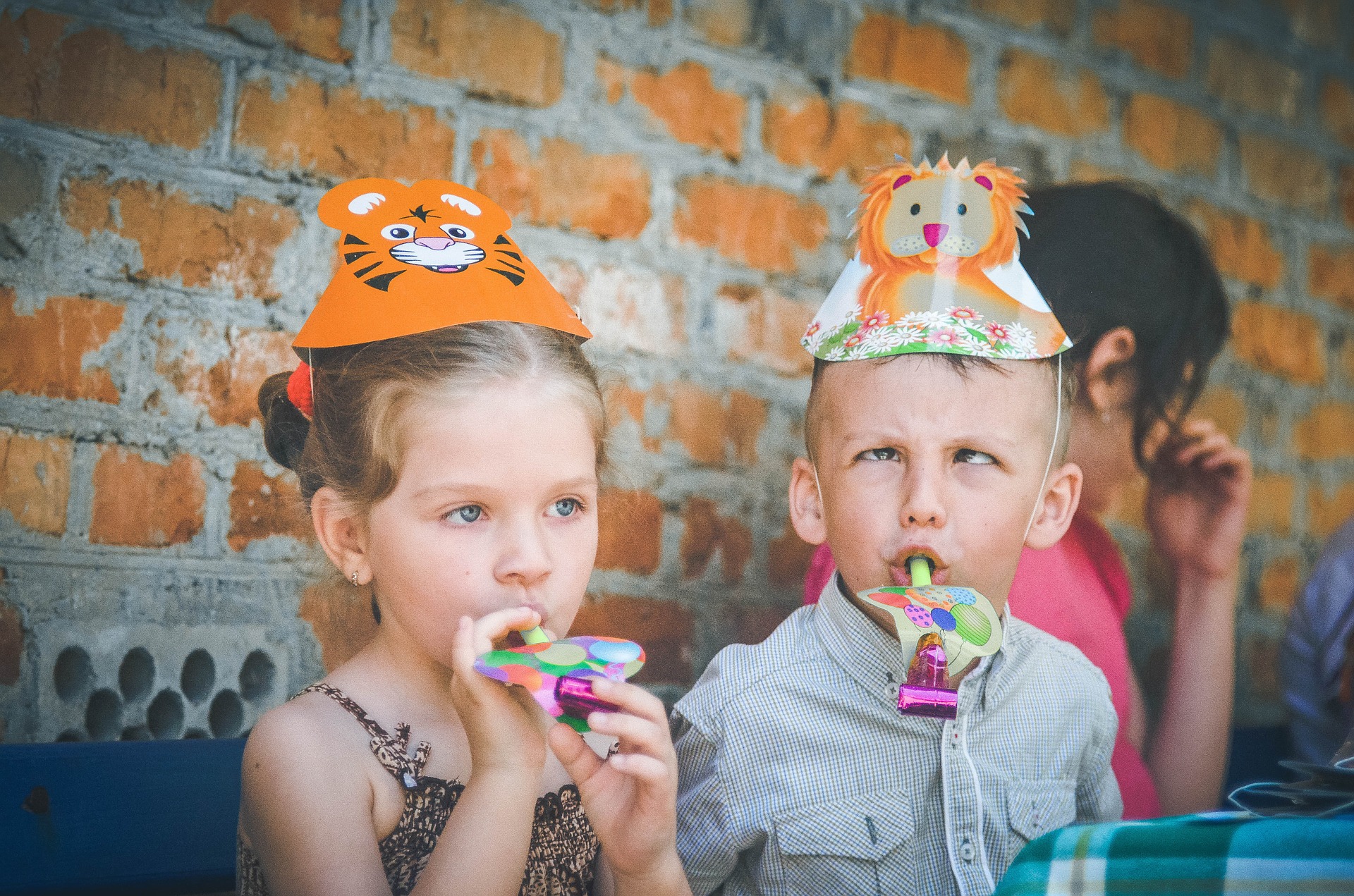 kids blowing a party trumpet